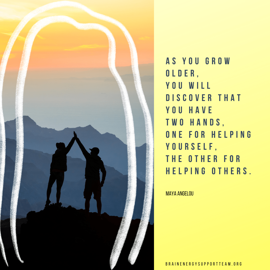 Two people holding hands at the top of a hill watching sunset