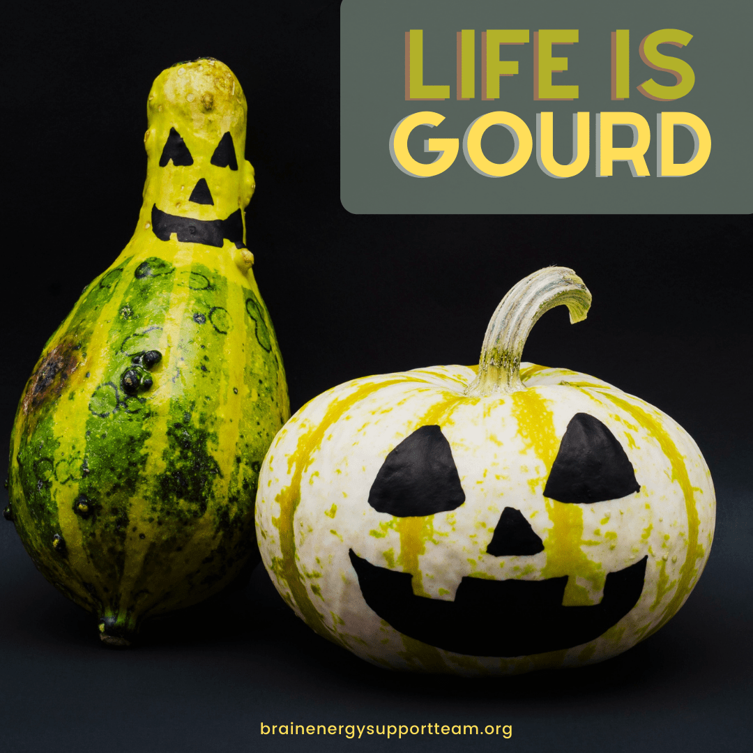 A squash and a pumpkin decorated with smiling faces in black paint for Halloween