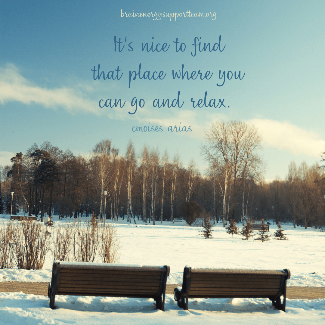 Two park benches, side by side, in winter in a park