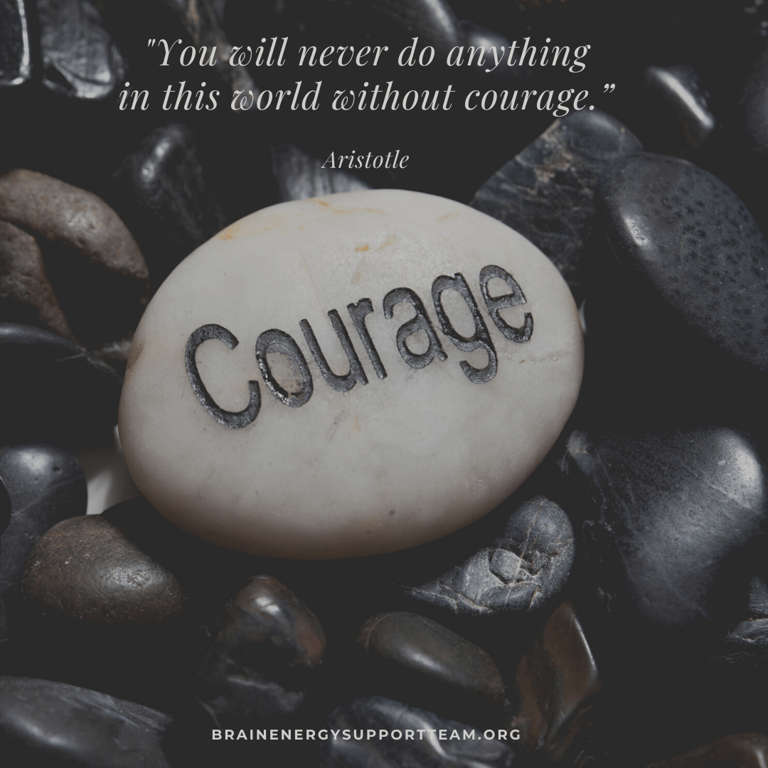 Text reads: You'll never do anything in this world with courage. Aristotle. Picture under words shows a a pile of smooth shiny dark stones, with a large light-colored stone with the word courage etched into it