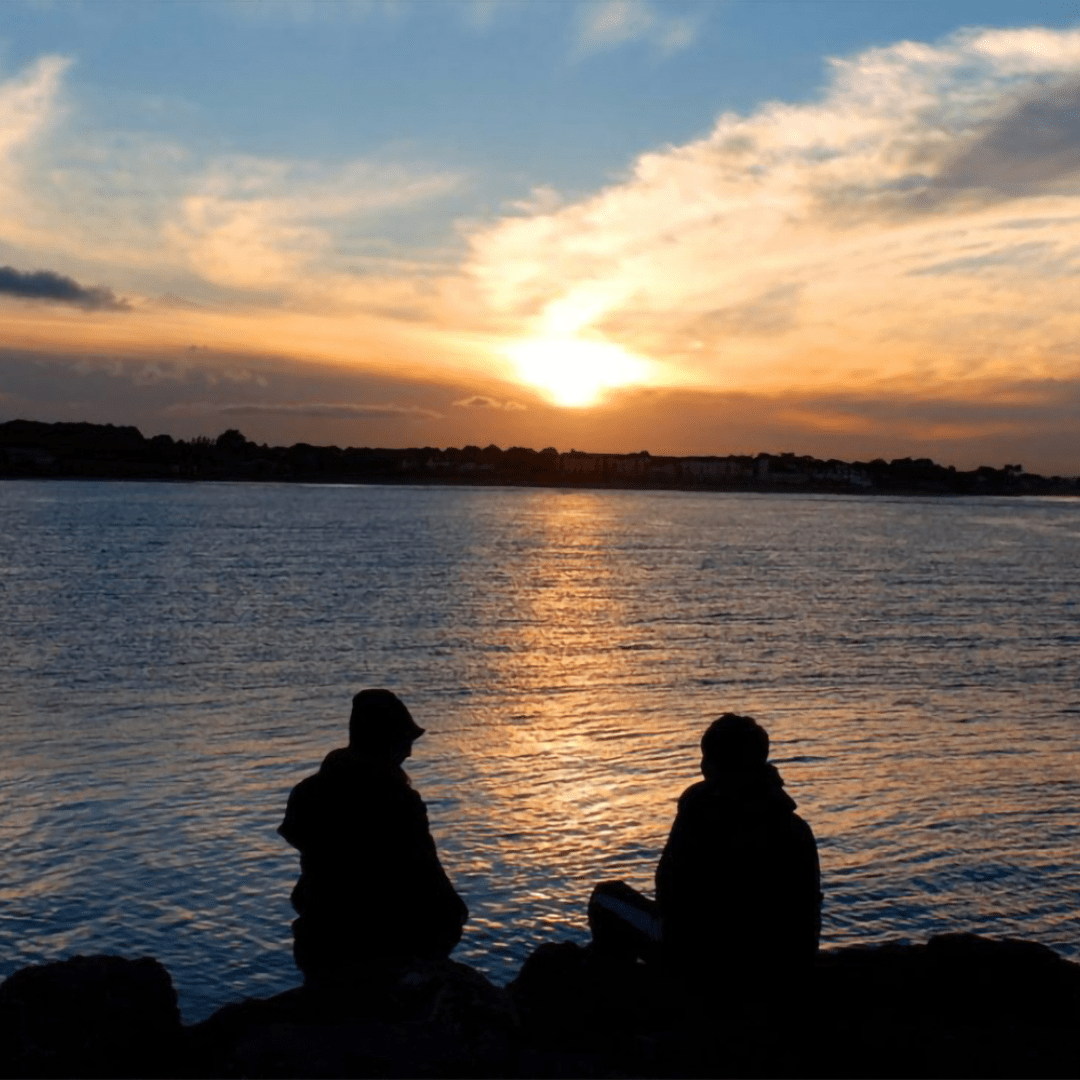 Man and Woman Sitting at Sunset June 2022