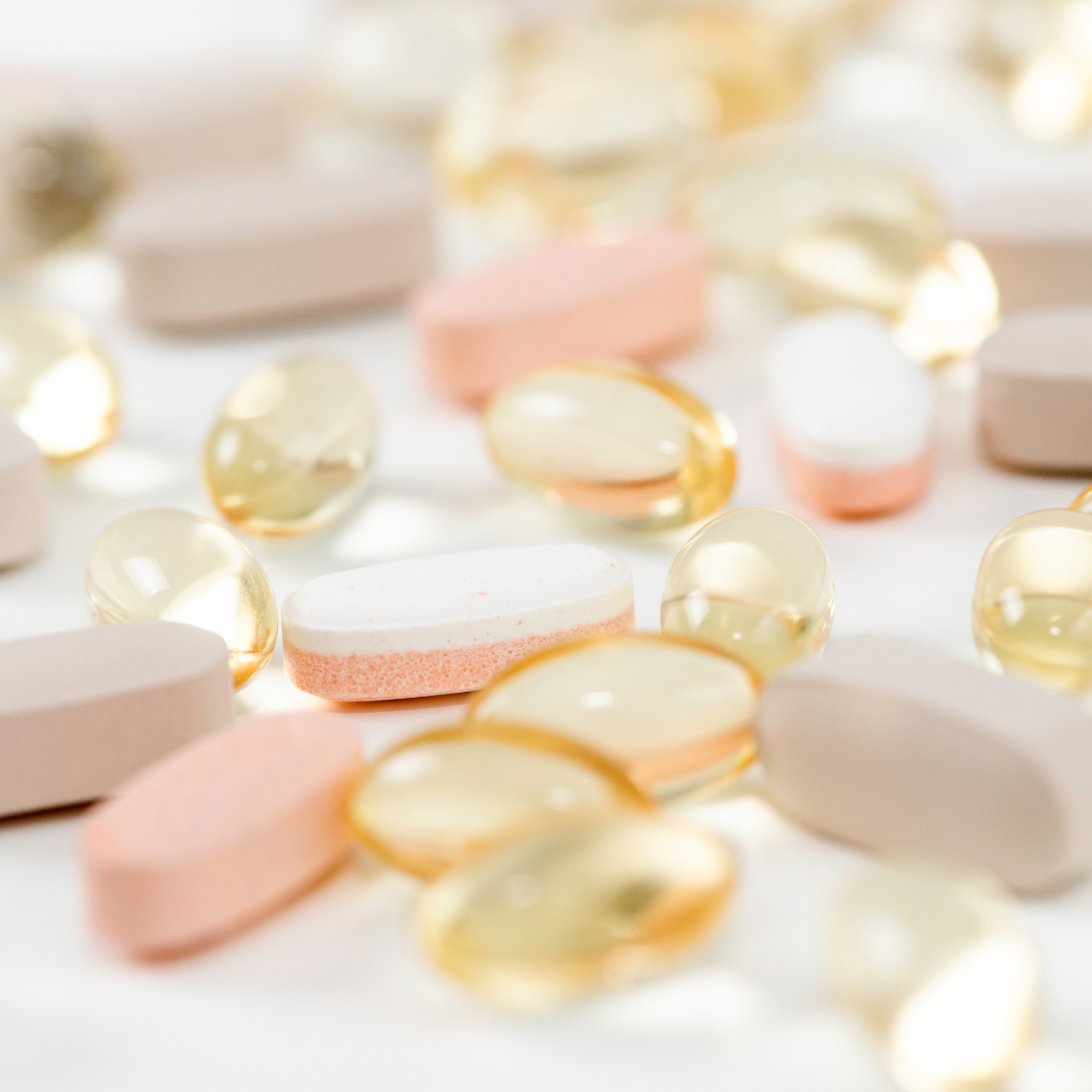 A photo of a counter covered with various supplements and vitamins