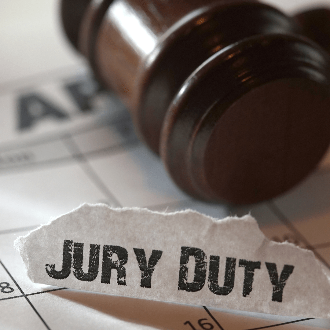 judges wooden gavel atop a paper that reads the words jury duty